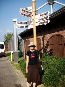 Me with European cities sign post near the Atomium in Brussels