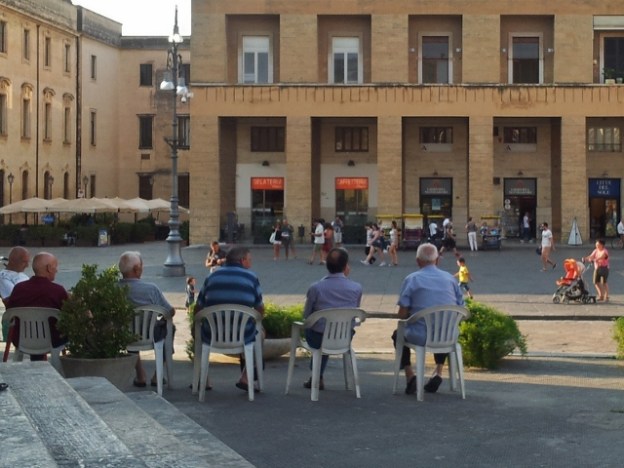 Old men on plastic chairs in Lecce, Puglia